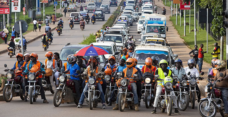 Boda boda riders await a traffic light to go green